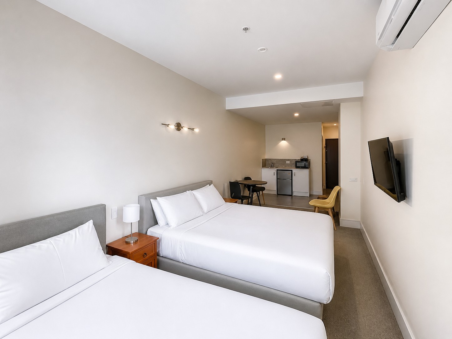 Deluxe Twin room with king and king-single beds and a kitchenette.
